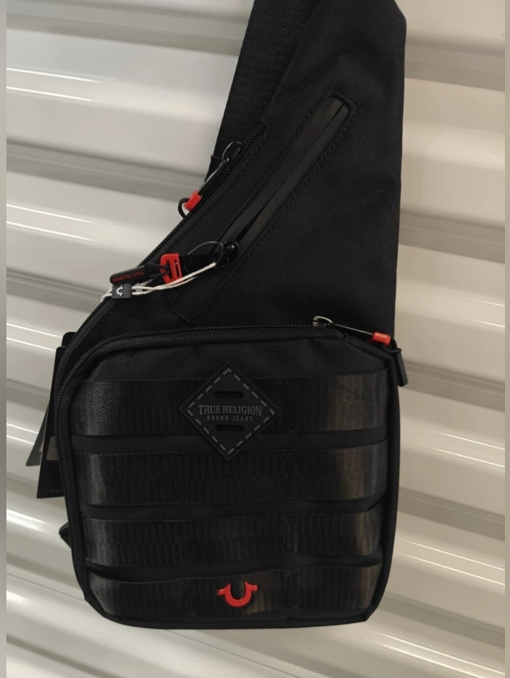 True Religion Black Sling Bag with Red Accents